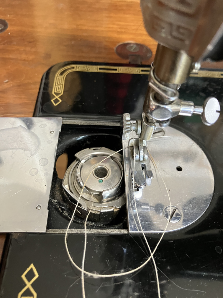 Throat plate with slide plate open